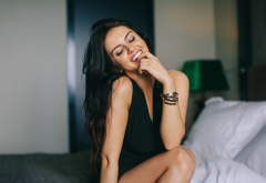 Aurela Skandaj, women, model, smiling, finger in mouth, sitting, closed eyes, black dresses wallpaper
